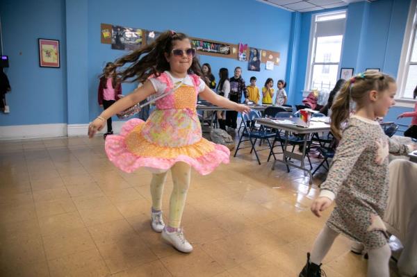 Sarina DeStefano, 7 years-old, left, and Olympia Moreau, 6 years-old, center, work on their runway looks.