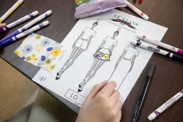 A student works on a mood board before their design is made.