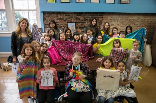 The Fashion Club kids pose with their work.