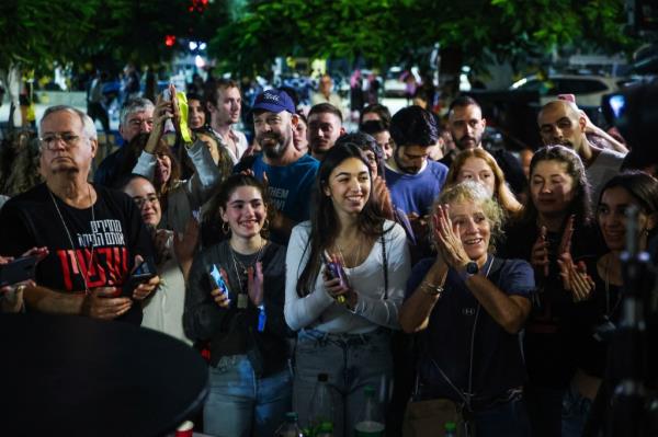 People react as the release of hostages is announced, amid a hostages-priso<em></em>ners swap deal between Hamas and Israel, in Tel Aviv, Israel, November 24, 2023.