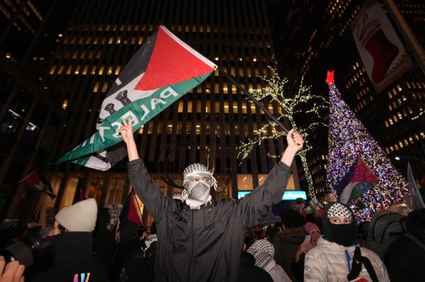 Pro-Palestine protestors gather outside the News Corporation building during a 