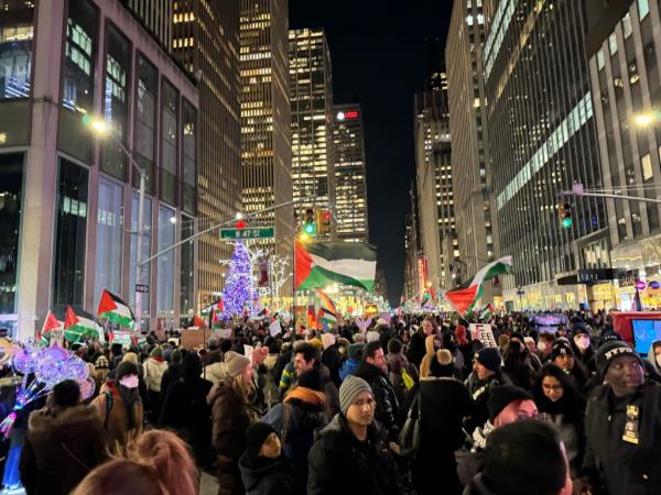 Flood the Tree protestors supporting Free Palestine are pictured outside 1211 Avenue of the Americas, the Fox headquarters, on Sixth Avenue, ahead of the Rockefeller Christmas Tree lighting tonight