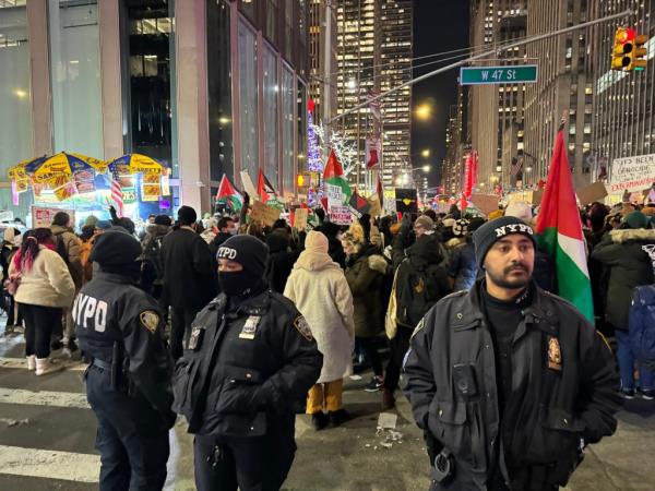 Flood the Tree protestors supporting Free Palestine are pictured outside 1211 Avenue of the Americas, the Fox headquarters, on Sixth Avenue, ahead of the Rockefeller Christmas Tree lighting tonight