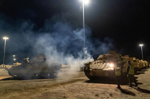 Stevedore drivers work through the night to load a Ukraine-bound co<em></em>nvoy of Bradley Fighting Vehicles load o<em></em>nto the carrier ARC Integrity at the Transportation Core Dock in North Charleston, South Carolina, U.S. January 25, 2023.