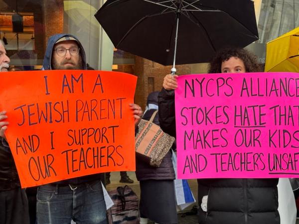 Protesters hold signs outside the Brooklyn Museum.