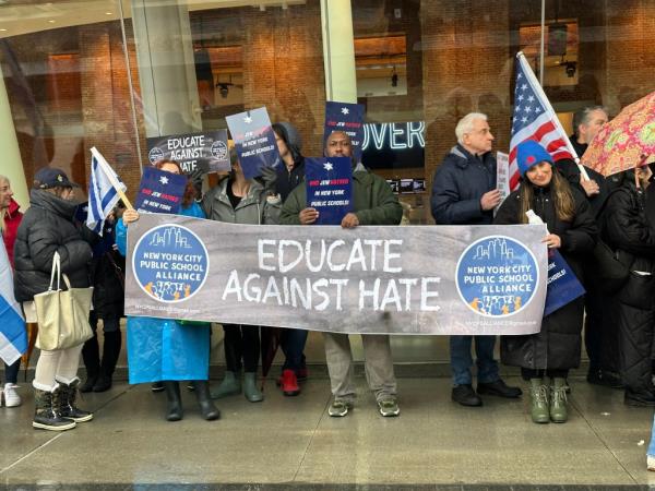 Protesters hold signs outside the Brooklyn Museum.