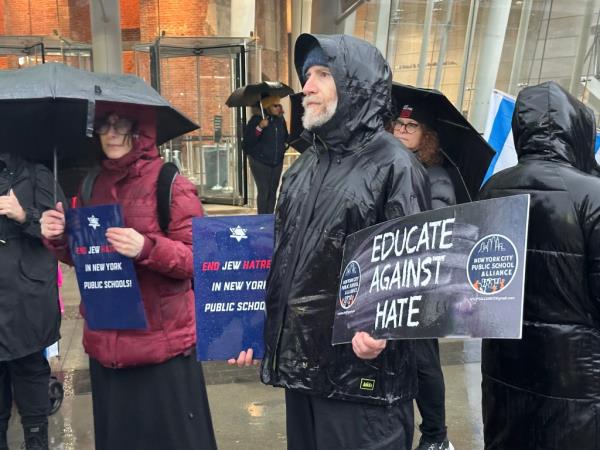 Protesters hold signs outside the Brooklyn Museum.