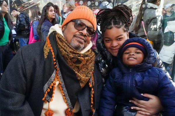 Brain Johnson and his daughters and grandson in front of the Nike store. 