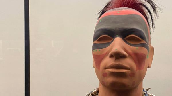 A mannequin painted to represent Native American face paints.