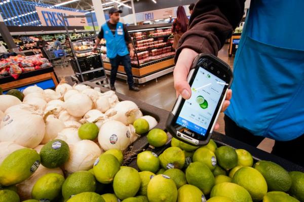  A worker scans onions, limes, and other produce