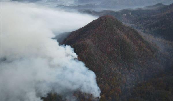 The 431-acre fire in Henderson County, North Carolina, has destroyed two homes, a cabin and an outbuilding, county officials said in a social media post Sunday that declared a state of emergency. 