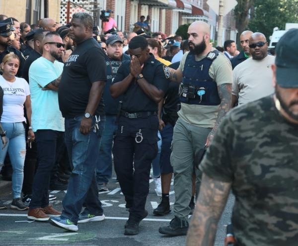 NYPD officers co<em></em>nsole themselves after an off-duty cop was shot and killed by his father.