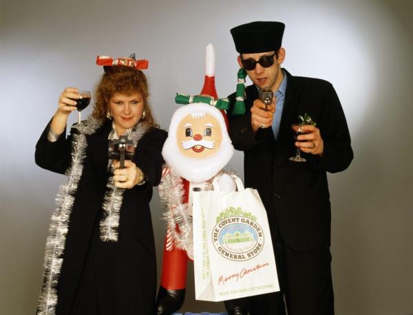 Singers Kirsty MacColl and Shane MacGowan with toy guns and an inflatable Santa.