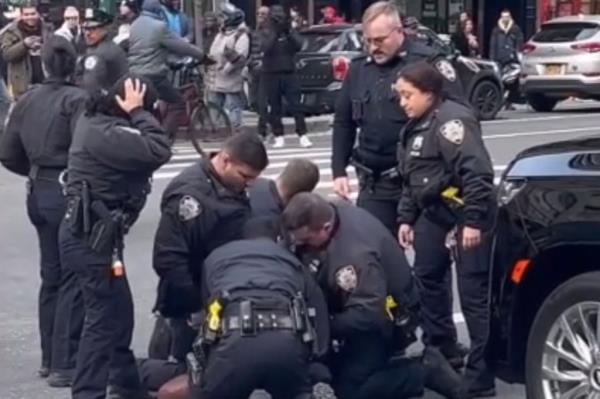 Police surrounding man on the floor