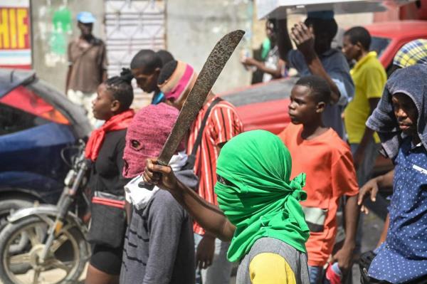 A man holds a machete during a demo<em></em>nstration against insecurity in Carrefour-Feuilles, a district of Port-au-Prince, Haiti, on August 14, 2023