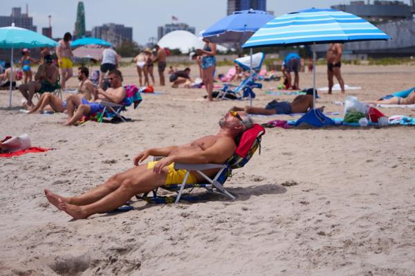 A man lays on the beach