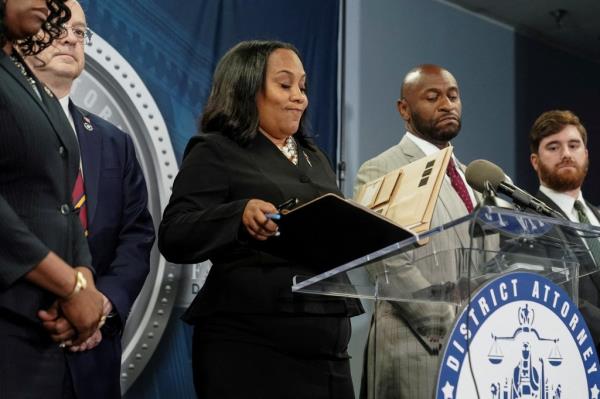 Fulton County District Attorney Fani Willis arrives at a press co<em></em>nference after a Grand Jury brought back indictments against former president Do<em></em>nald Trump and his allies in their attempt to overturn the state's 2020 election results.